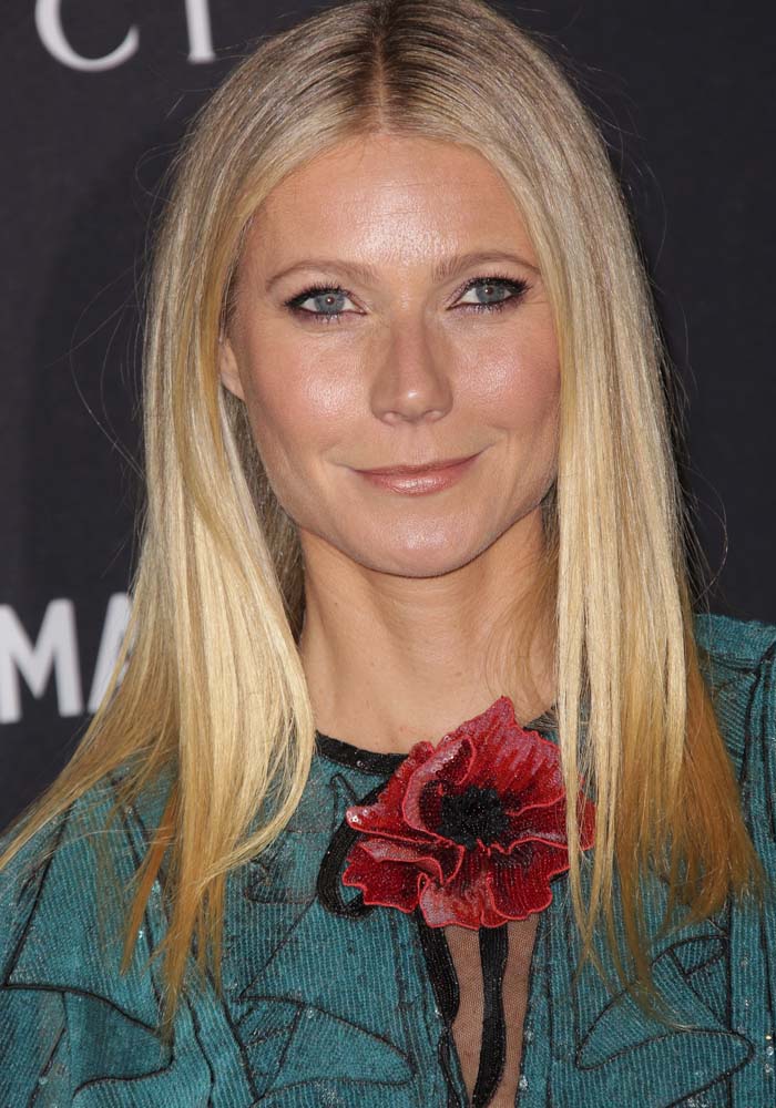 Gwyneth Paltrow stuns in a teal Gucci dress adorned with a bold red floral embellishment at the LACMA 2015 Art+Film Gala